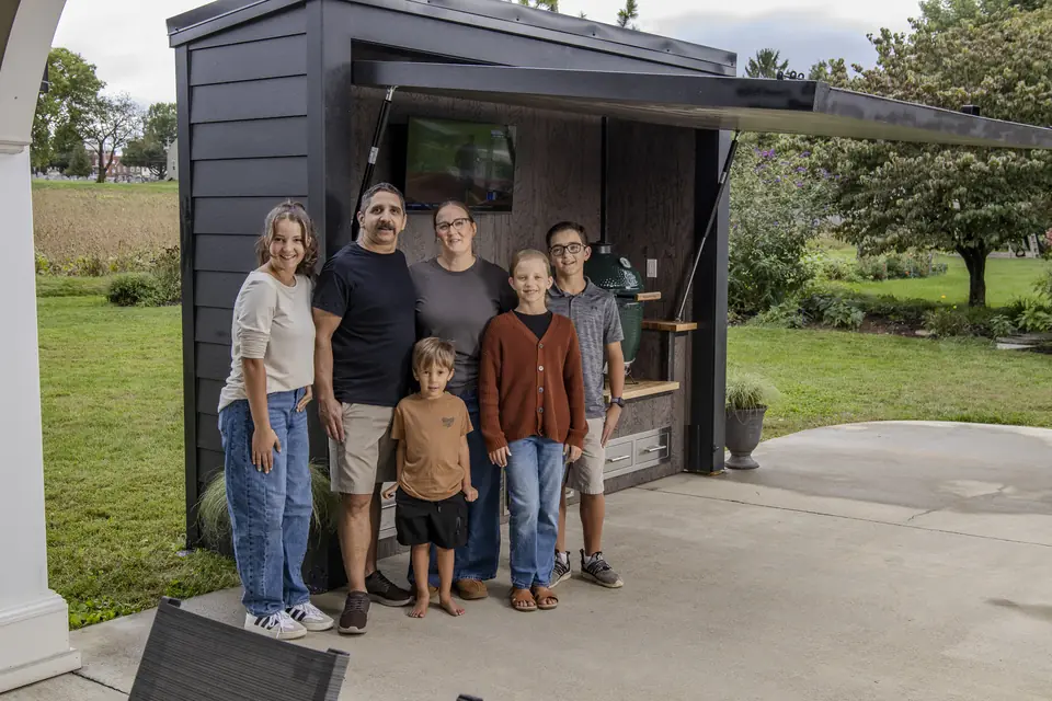 Dave with his wife and four children in front of their Flamehouse