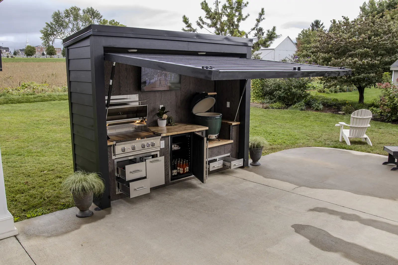 A Flamehouse open with grill, ceramic egg, fridge and storage