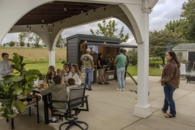 Family and friends gathered under the pavilion next to the Flamehouse